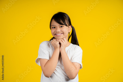 Closeup portrait of little asian girl asking something