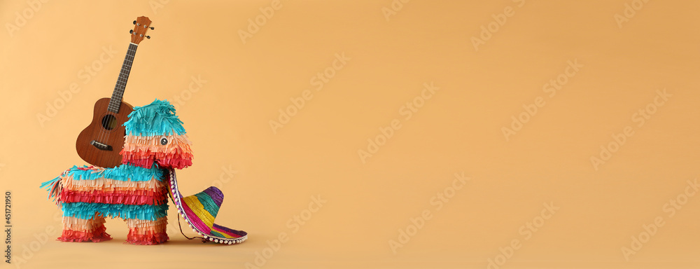 Creative pinata, guitar and sombrero on color background with space for text Creative pinata, guitar and sombrero on color background with space for text