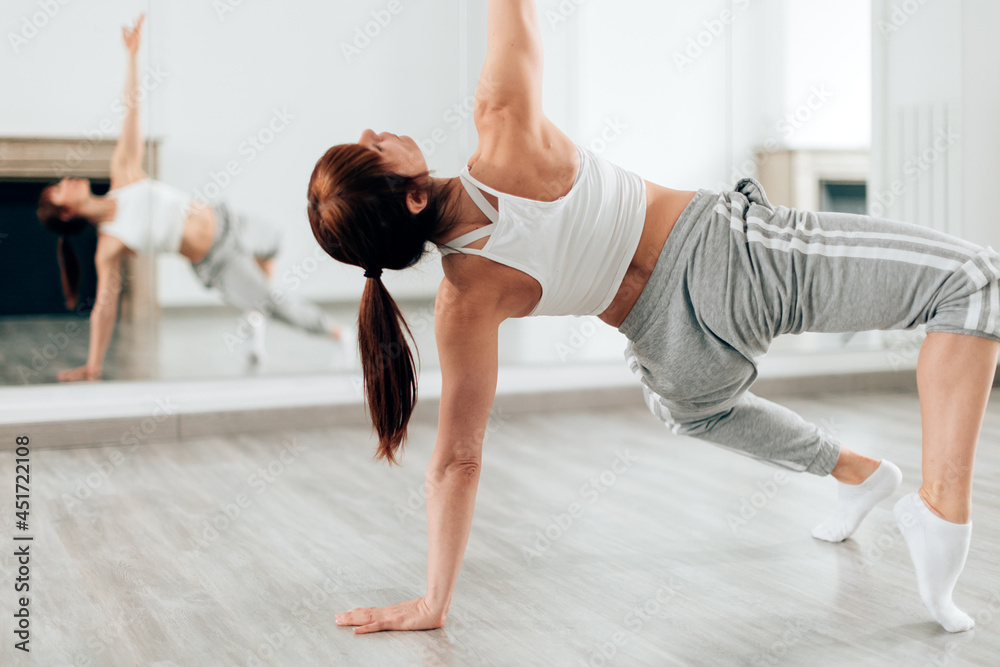 Naklejka premium Sport dancer woman doing class routine inside dancing studio