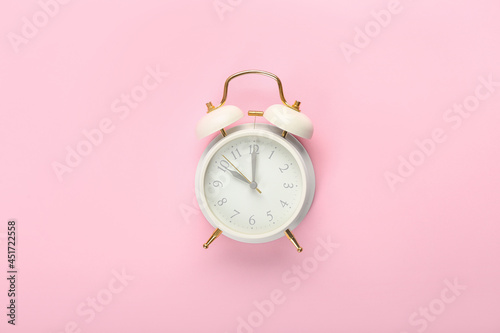 Stylish alarm clock on color background