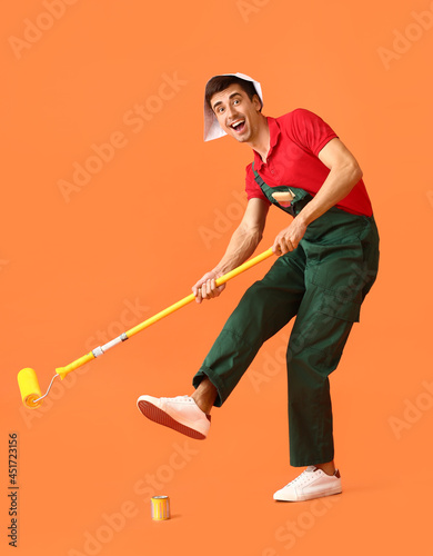 Male painter with roller br...