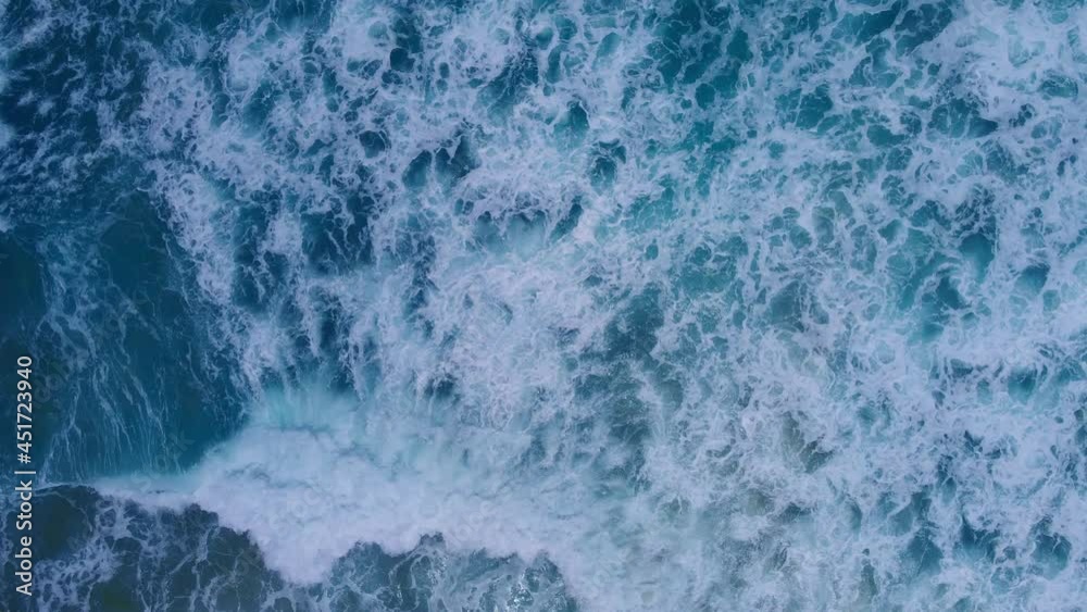 (Top view) drone view shot. on the Andaman coast. Beautiful big wave seawater wave texture. The sea and large ripples that wash against the shore are filled with beautiful soft white sponges. (Top view) drone view shot. on the Andaman coast. Beautiful big wave seawater wave texture. The sea and large ripples that wash against the shore are filled with beautiful soft white sponges.
