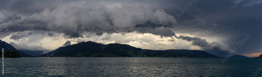 Panoramic view to lake attersee at storm cloudy sky with alps mountain. Moody weather, Austria, salzburg region.