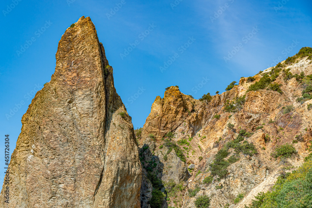 Mountains, mountain peaks in the blue sky. Amazing view. Mountain landscape on the sea coast.At the top of the cliff. Landscape with rocks. The concept of clean mountain air.