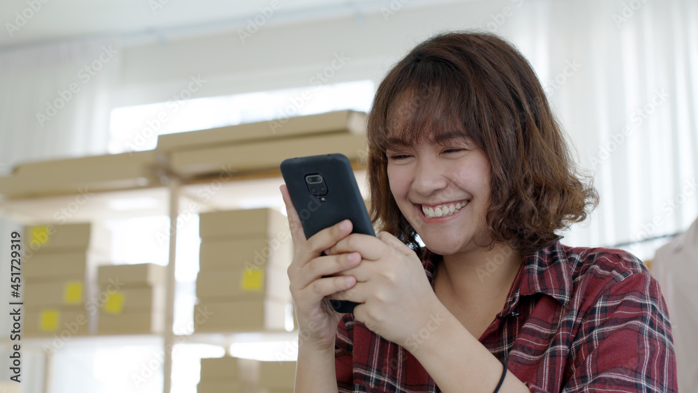 Asia female people sell fashion clothing online shop store or young sme owner crazy enjoy excited face gesture to good news of P2P lending cash loan approve result, win sale goal on digital cellphone.
