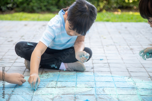Children playing with colored chalks