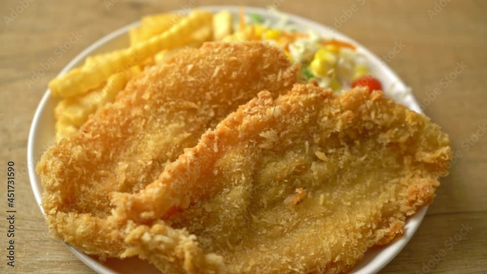 fish and chips with mini salad on white plate fish and chips with mini salad on white plate