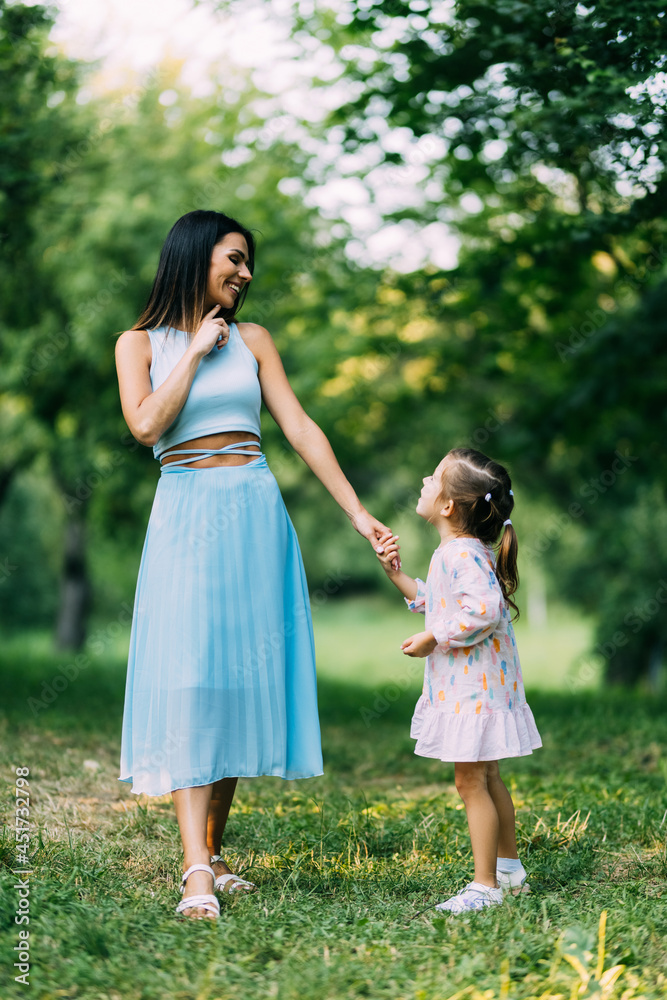 Mother and daughter are having fun in summer park Mother and daughter are having fun in summer park