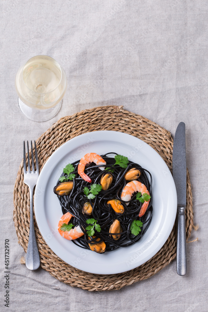 Black spaghetti pasta with seafood, shrimps, mussels and parsley