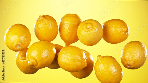 Fresh lemons flying with wa...