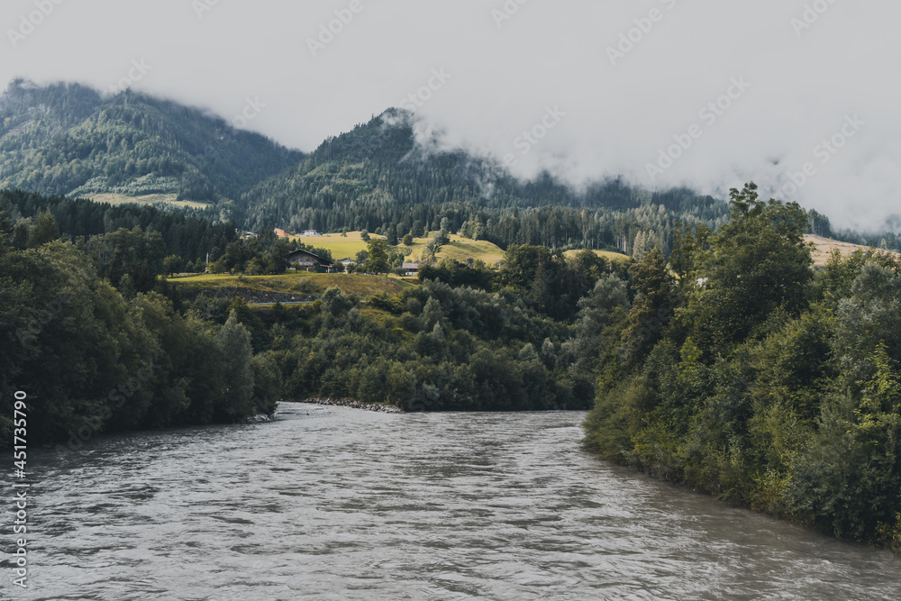 river in the mountains with fog