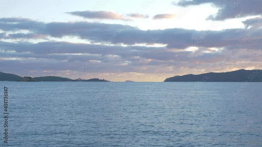 Distant View Of Whitsunday Islands At The Coastline Of Coral Sea Under Cloudy Sky In Queensland, Australia. static shot Distant View Of Whitsunday Islands At The Coastline Of Coral Sea Under Cloudy Sky In Queensland, Australia. static shot