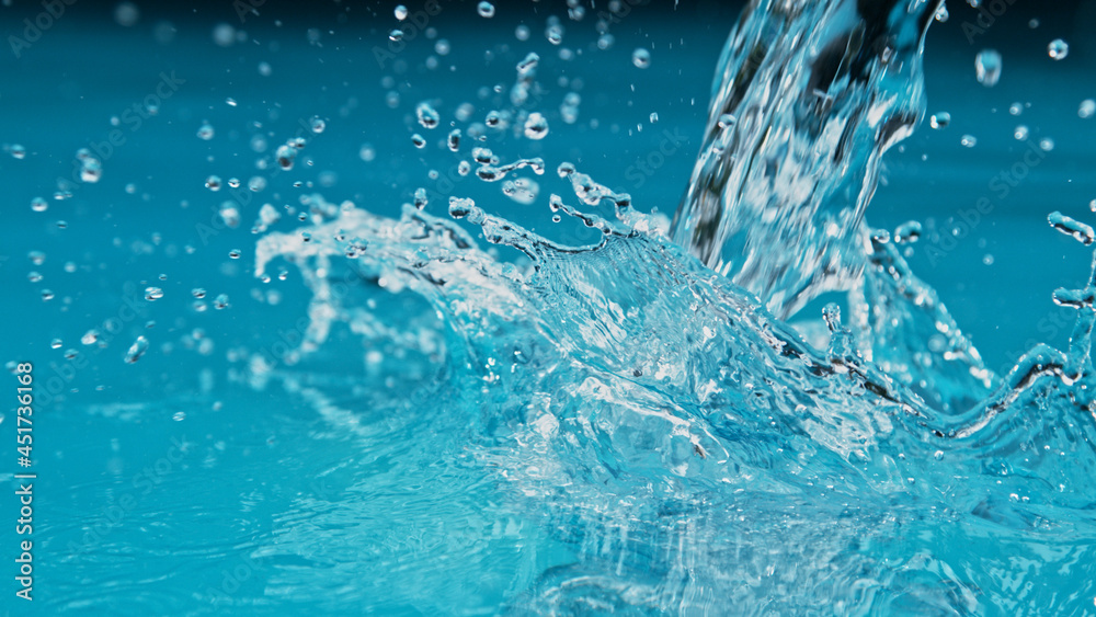 Freeze motion of water splash isolated on azure background. Freeze motion of water splash isolated on azure background.