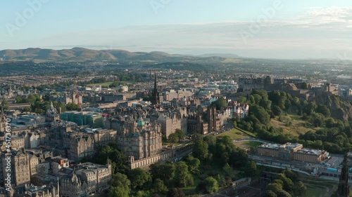 Long dolly back drone shot over central Edinburgh golden hour