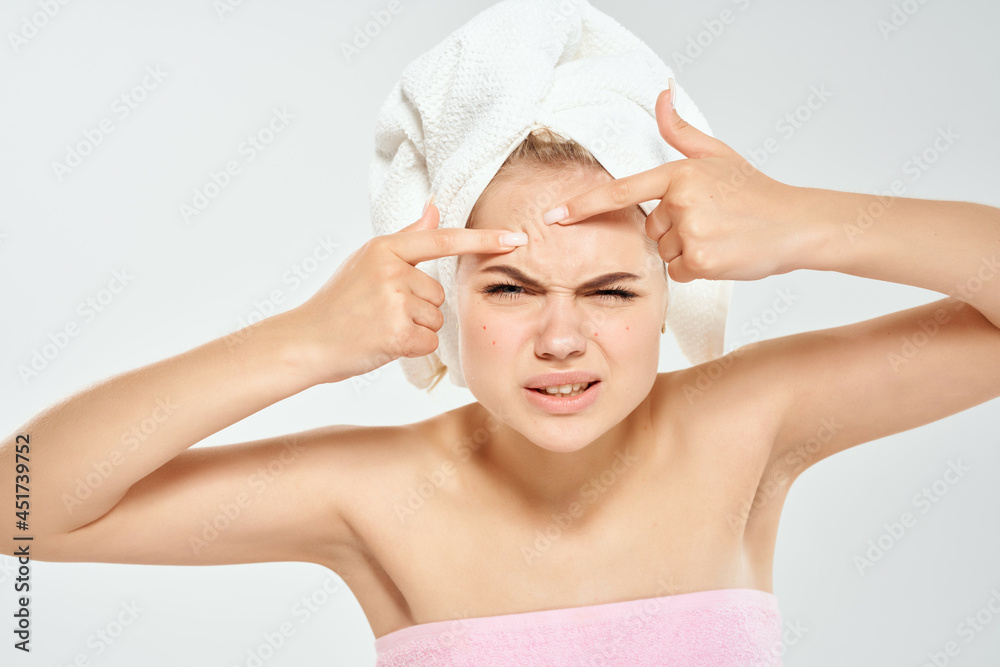 woman with a towel on her head squeezes out pimples on her face clean skin health woman with a towel on her head squeezes out pimples on her face clean skin health