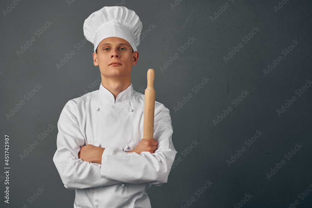 a man in a chef's uniform working in a restaurant cooking a man in a chef's uniform working in a restaurant cooking