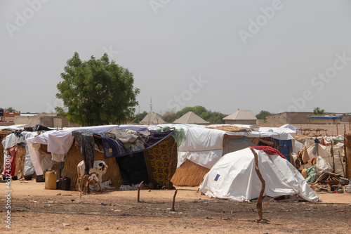Refugee camp made of local materials and plastic sheeting, people living in very poor conditions, internally displaced persons  - IDP photo