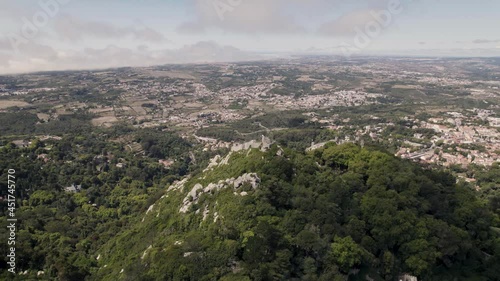 Historic medieval stone ruins of Castle of the Moors in Sintra Portugal, aerial pan shot. photo