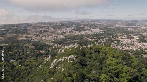 UNESCO tourist landmark, Castle of the Moors on hill in Sintra Portugal, aerial pan shot. photo