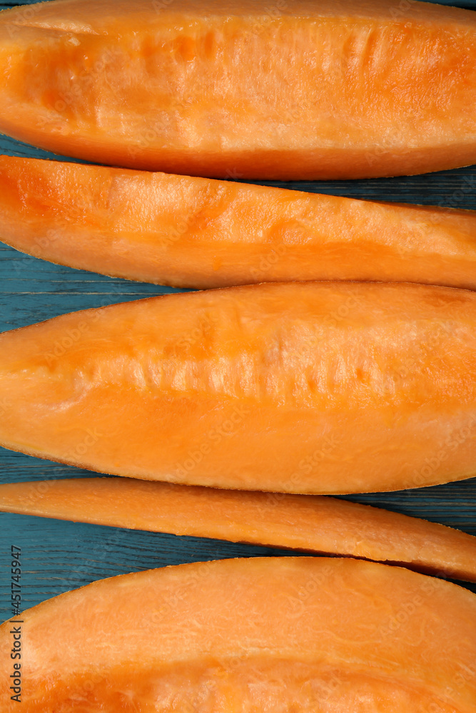 Ripe melon slices on wooden background, close up Ripe melon slices on wooden background, close up