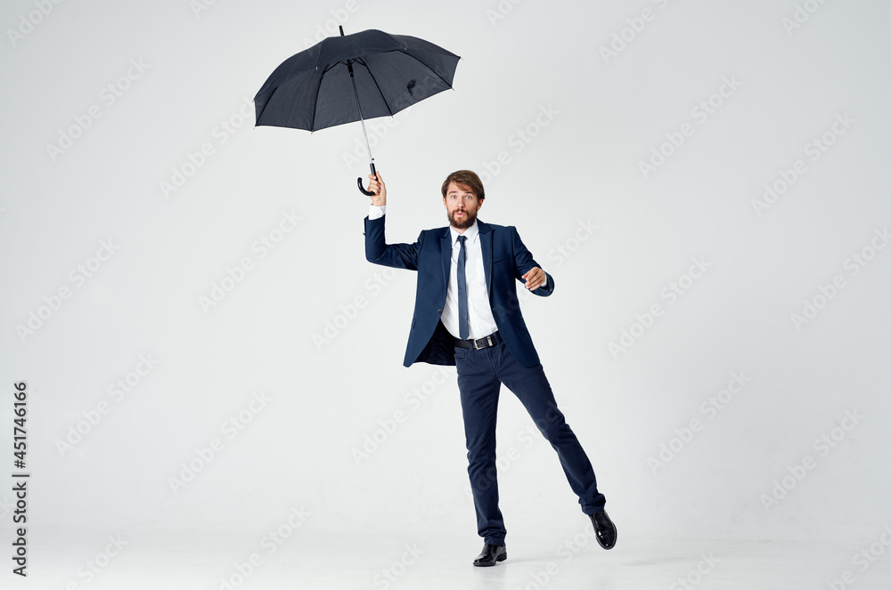 emotional man in a suit with an umbrella in his hands bad weather emotional man in a suit with an umbrella in his hands bad weather