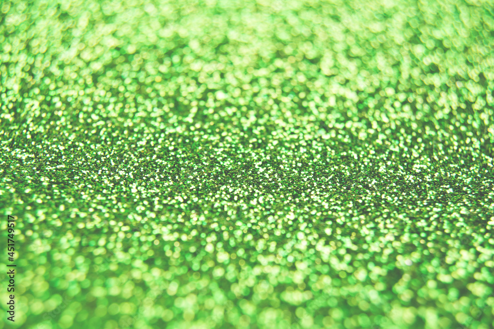 Fototapeta premium Abstract shiny blurred green background. Textured glittering backdrop for your projects. Copy space