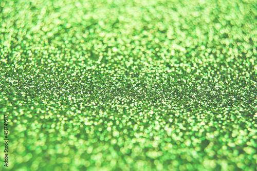 Abstract shiny blurred green background. Textured glittering backdrop for your projects. Copy space
