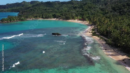 A Sunny Day In The Caribbean Beach With Palmstree And The Waves with mountains photo