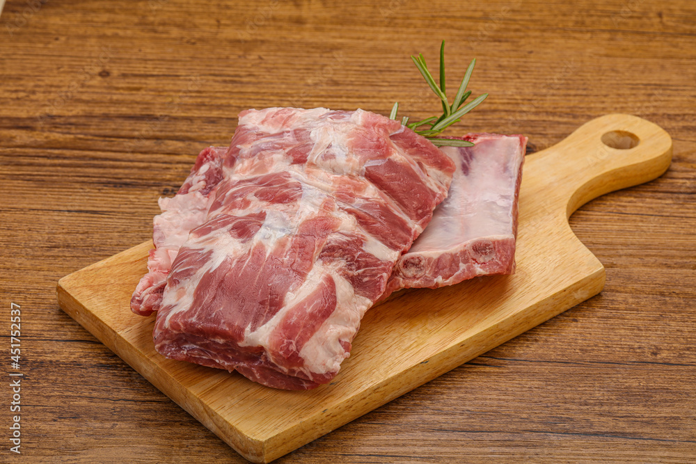 Raw pork ribs served rosemary