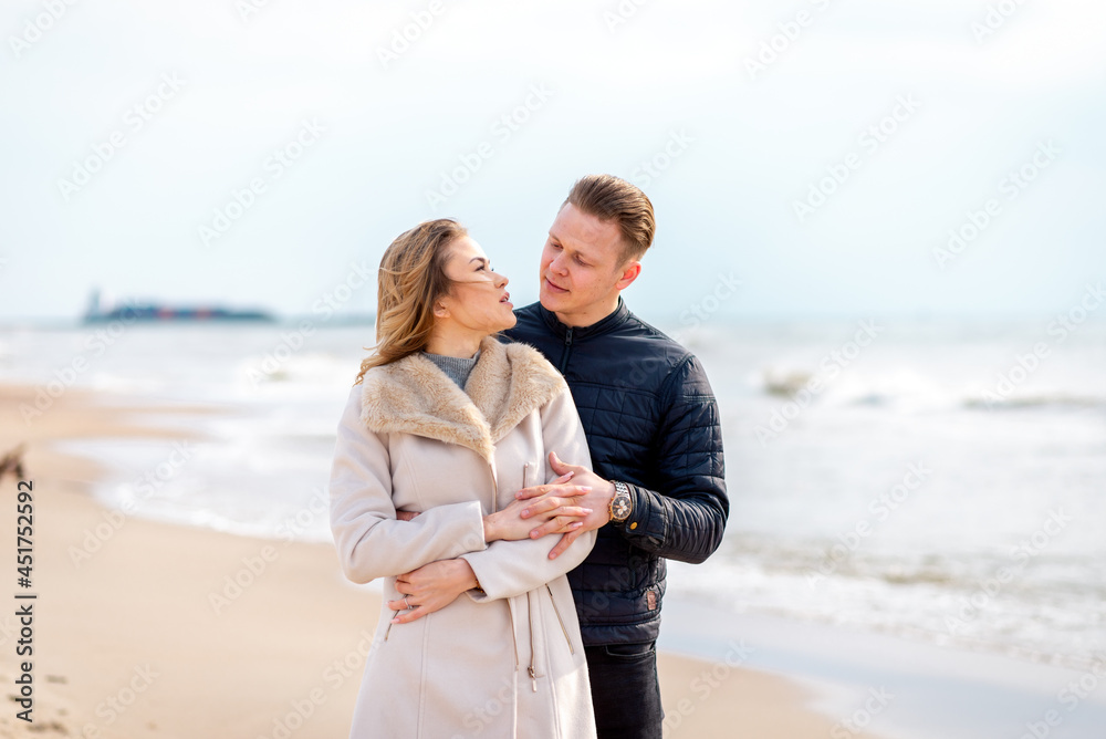 Two Young couple standing enjoying on a coast and enjoying each other.Summer,spring,autumn vacation.