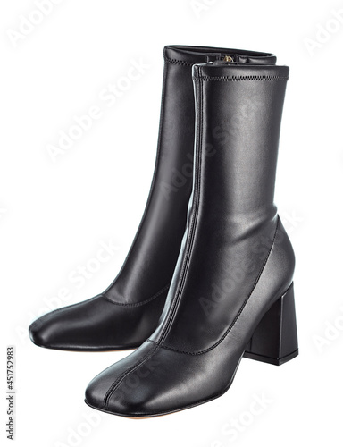 Beautiful pair of classic demi-season boots with a blunt toe, high heels, made of black leather, isolated on a white background.