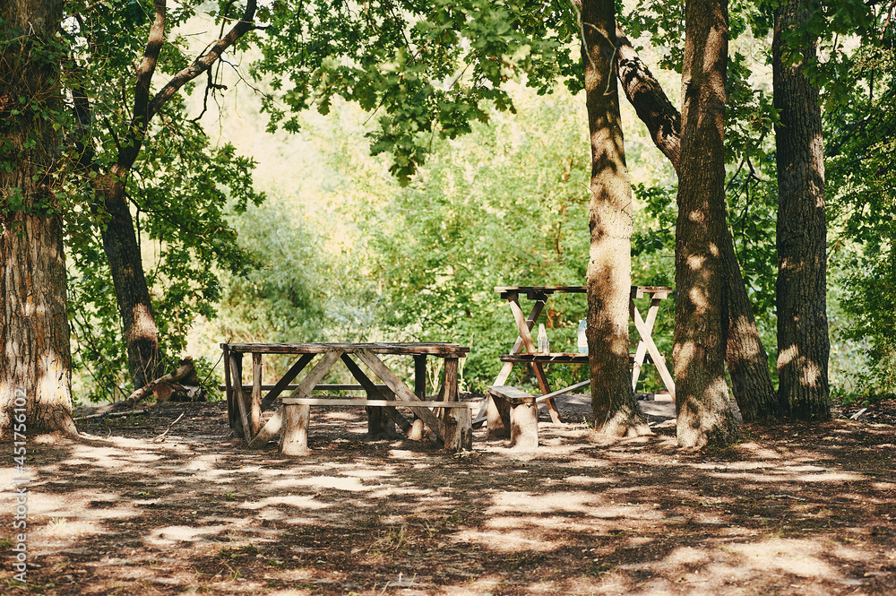 Homemade wooden table with benches in the forest Homemade wooden table with benches in the forest
