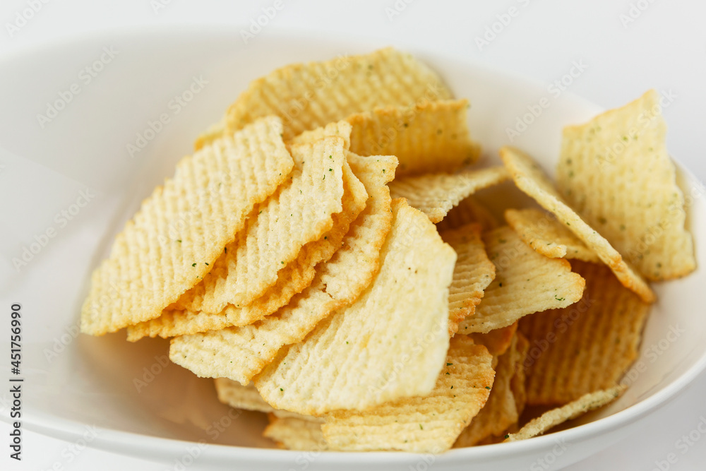 Salty chips in a plate. An appetizing snack. Close-up. Salty chips in a plate. An appetizing snack. Close-up.