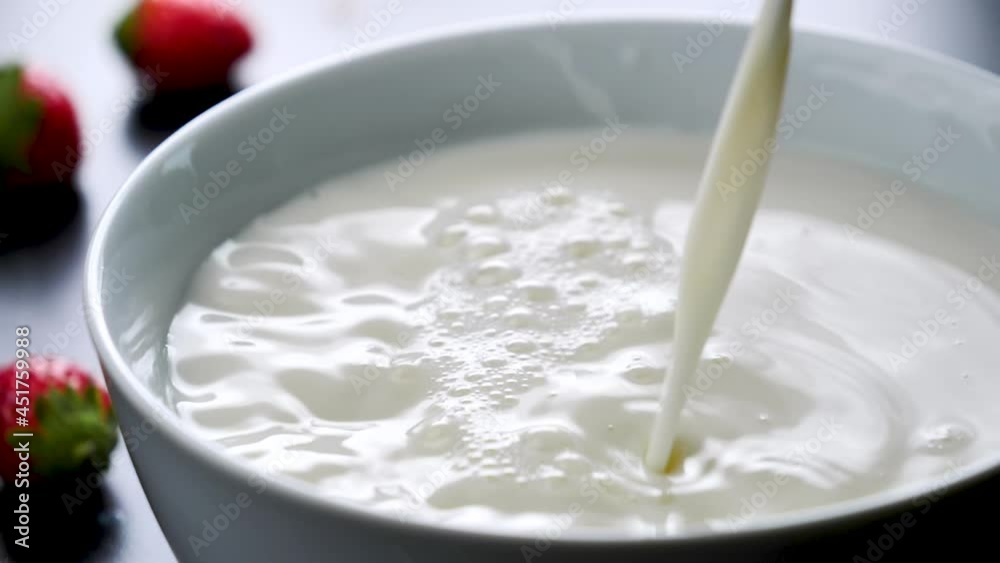 milk pouring in bowl in slow motion milk pouring in bowl in slow motion