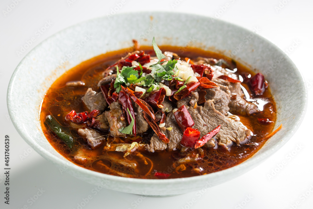 Chinese spicy soup with beef, vegetables and chili pepper isolated on white background Chinese spicy soup with beef, vegetables and chili pepper isolated on white background