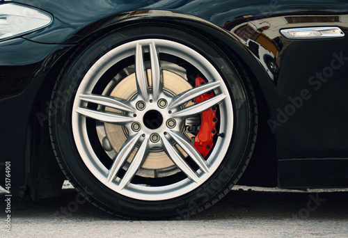 gray rims, tires and brake discs of the sports car © oktay