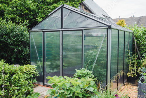 Greenhouse with extra thick poycarbonate panels for insulation in a garden