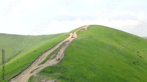 aerial view suv vehicle going up by hill to the top of mountain photo