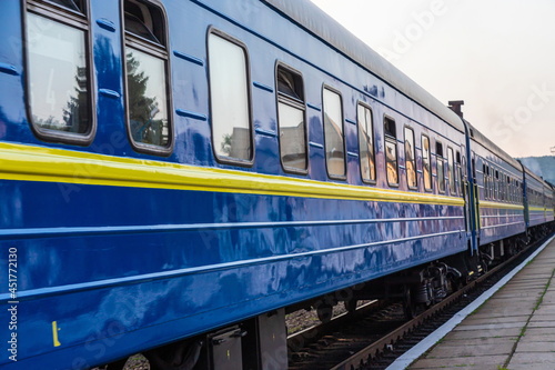 a blue passenger train travels along the track