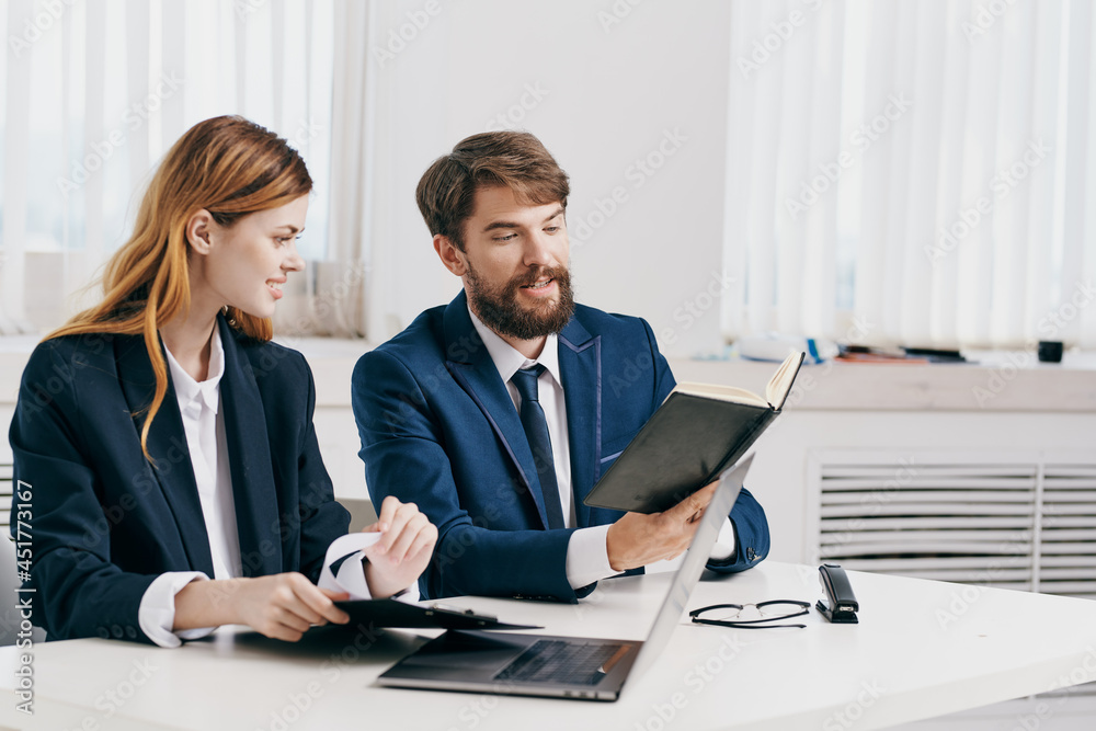 man and woman managers sitting at the table in front of laptop professionals technology man and woman managers sitting at the table in front of laptop professionals technology