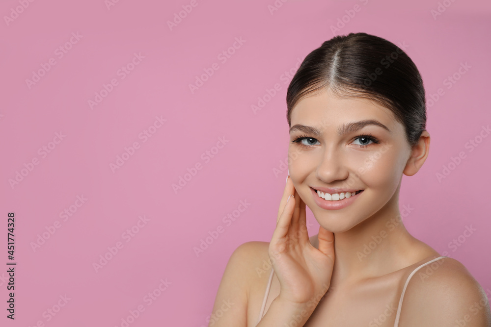 Portrait of pretty girl on pink background, space for text. Beautiful face with perfect smooth skin Portrait of pretty girl on pink background, space for text. Beautiful face with perfect smooth skin