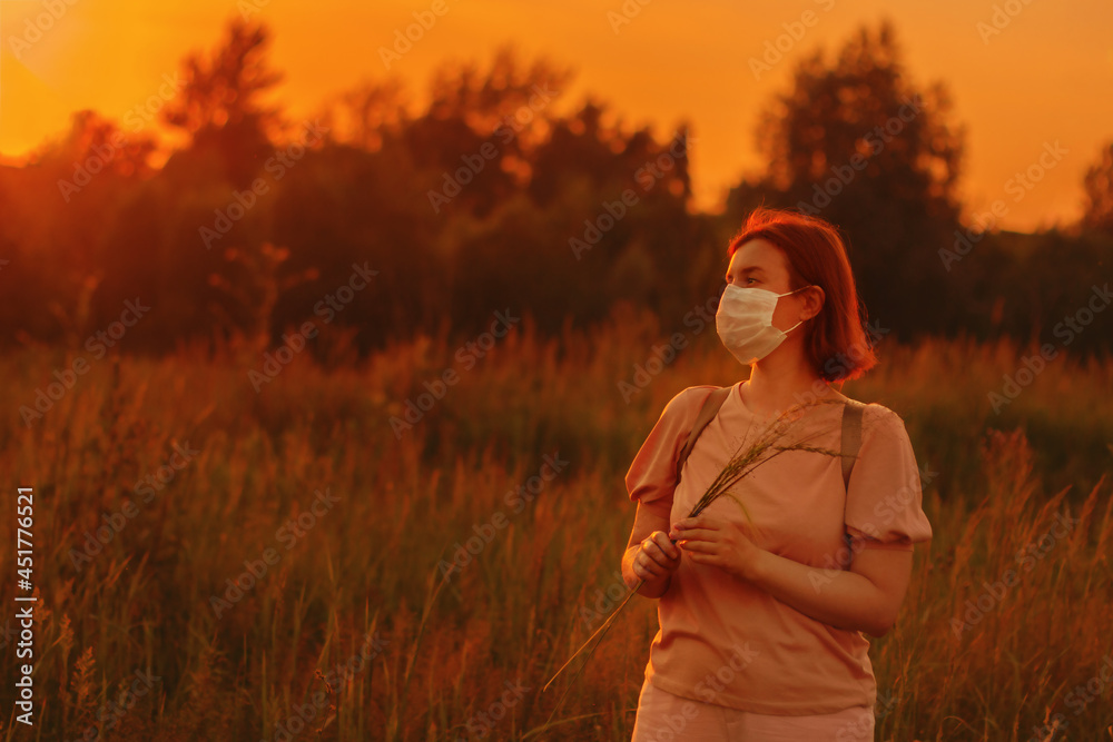 © Nadezhda - Redhead girl young wearing face mask outside during Coronavirus COVID-19 quarantine. Middle age woman walking in summer meadow alone and dreaming. © Nadezhda - Redhead girl young wearing face mask outside during Coronavirus COVID-19 quarantine. Middle age woman walking in summer meadow alone and dreaming.
