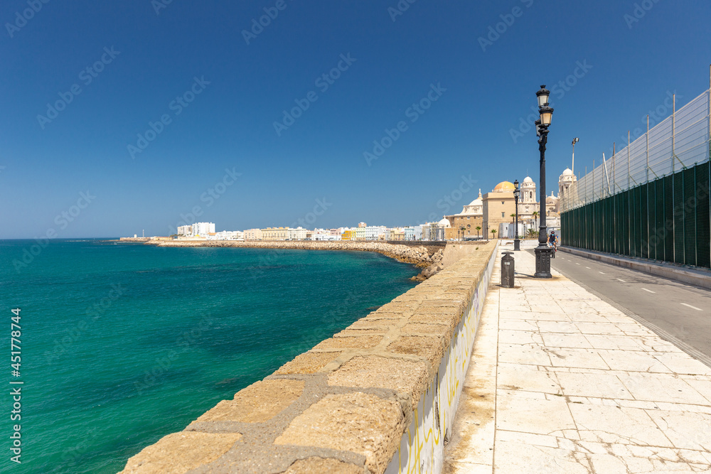 View of Cathedral Of Cadiz. Panoramic view of the city with promenade area and Mediterranean sea. Touristic travel destination in South of Spain.