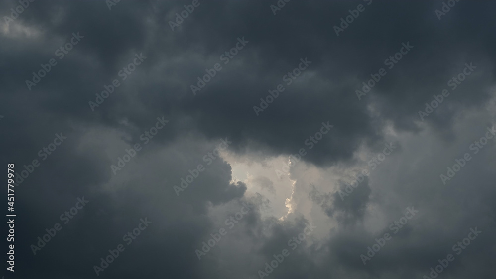 Rain clouds. the sun breaks through the clouds. Lighting in dark stormy cloudy