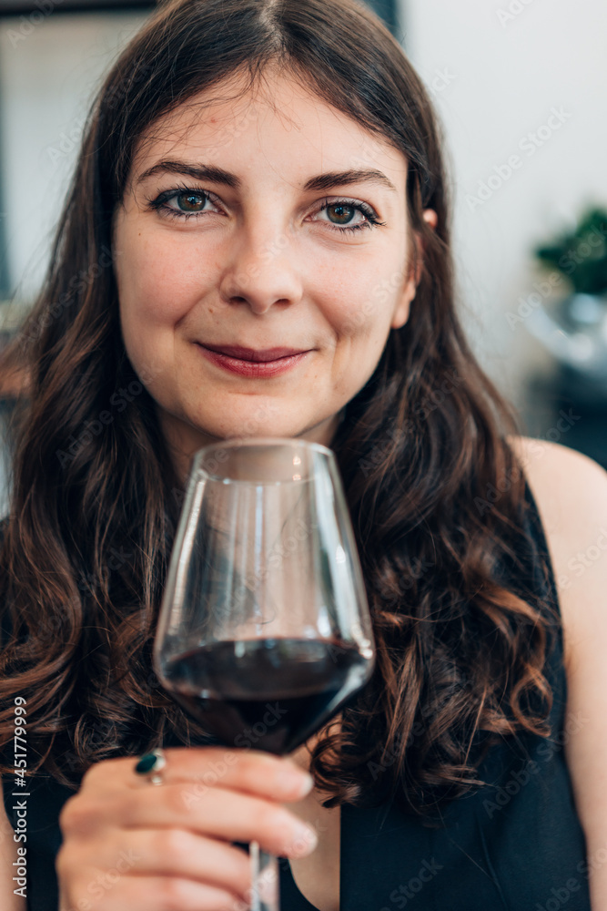 Happy woman having fun while drinking wine indoor at home - Focus on face Happy woman having fun while drinking wine indoor at home - Focus on face