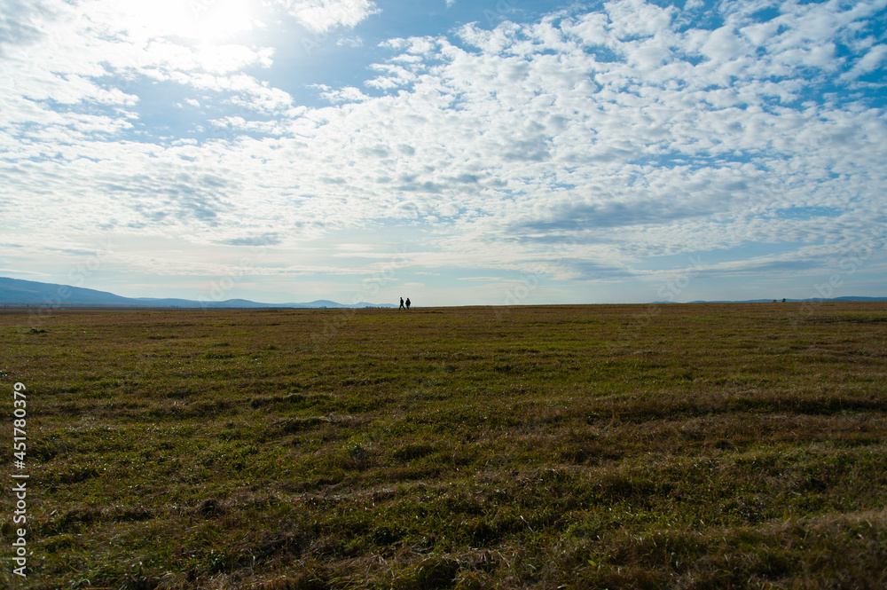 autumn landscape, field and blue sky with clouds