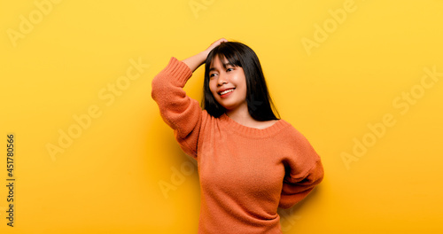 Cute Asian girl smiling on yellow background. Empty, young woman. Place for advertisement. copy space © FOTO SALE