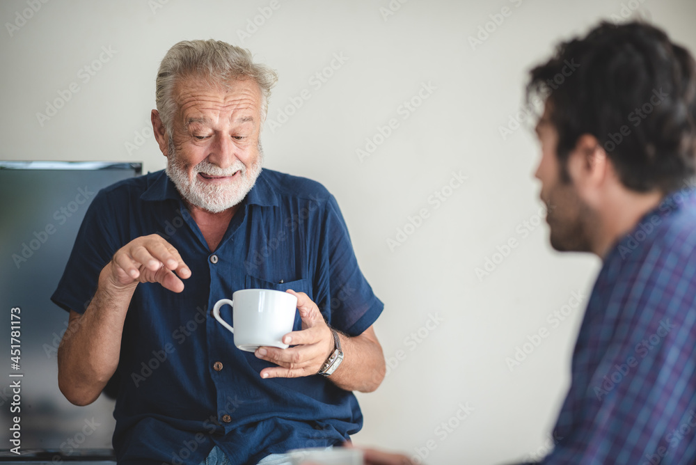 Adult hipster son and old senior father stay for work at home, two generations have a beard talking together and relaxing with smile, happy enjoy living to isolation quarantine at home, father's day