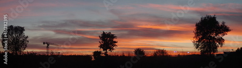 a wide angle view of an orange cloudy sunset