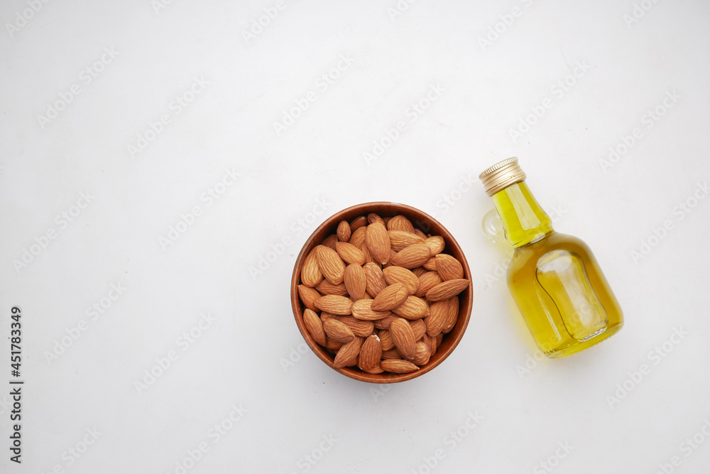 Almond oil in bottle on wooden background. Almond oil in bottle on wooden background.